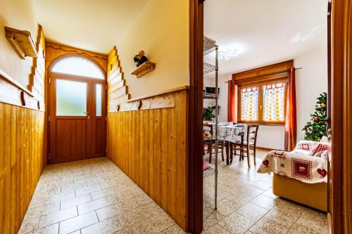 a hallway with a dining room with a table at Appartamenti Le Bistrot in Saint Nicolas