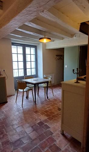 a dining room with a table and chairs at Logis La Vachère in Avallon