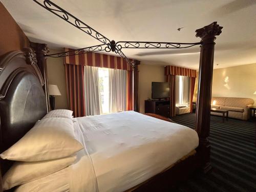 a bedroom with a large bed with a canopy at Express Inn Leesville Ft Johnson, SureStay Collection by Best Western in Leesville