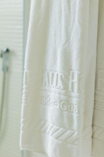 a white towel hanging in a bathroom window at The Falls Hotel in Guarujá
