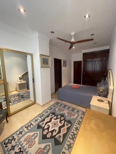 a bedroom with a bed and a large mirror at Marbella Beach Front Edificio Mayoral Centro Ciudad y Primera Línea Playa Muy Amplio y Espacioso in Marbella