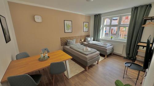 a living room with a couch and a table at Aura - Nula #2 - 2 Zimmer, 4 Betten, Küche, Balkon, Waschmaschine in Merseburg