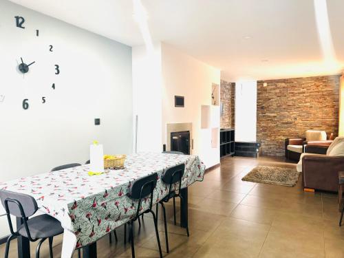 a dining room with a table with chairs and a fireplace at Casa Avô Cantoneiro - Cepães Marinhas in Cepães