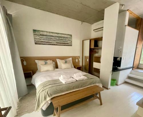 a bedroom with a bed with two towels on it at Terral Suites in Mar de las Pampas