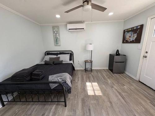 a bedroom with a bed and a ceiling fan at Bright & Comfortable Bungalow! in East Tulsa