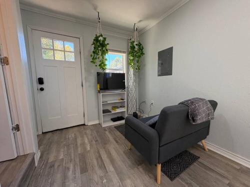 a living room with a couch and a television at Bright & Comfortable Bungalow! in East Tulsa