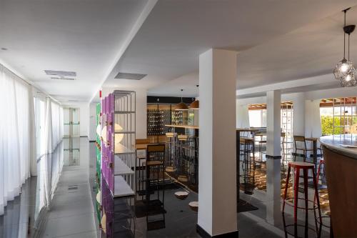 a kitchen and dining room with white walls and white columns at Hotel San Teodoro in San Teodoro