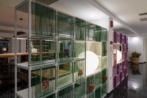 a wall of green blinds in a room at Hotel San Teodoro in San Teodoro