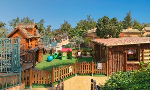 a playground with a slide and a play structure at Green Garden Eco Resort in Playa de las Americas