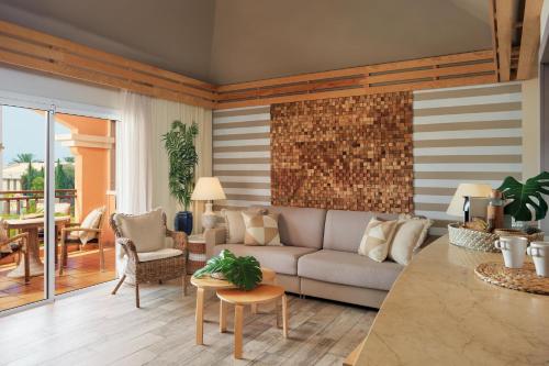 a living room with a couch and a table at Green Garden Eco Resort in Playa de las Americas