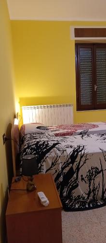 a bedroom with a bed and a desk with a telephone at Narniandum Est in Narni