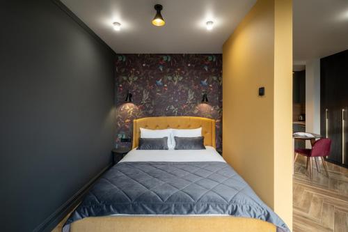 a bedroom with a bed with a floral wall at Ridge Apartments in Chernivtsi