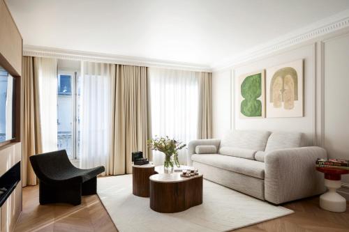 a living room with a couch and a table at HIGHSTAY - Luxury Serviced Apartments - Centre Pompidou in Paris