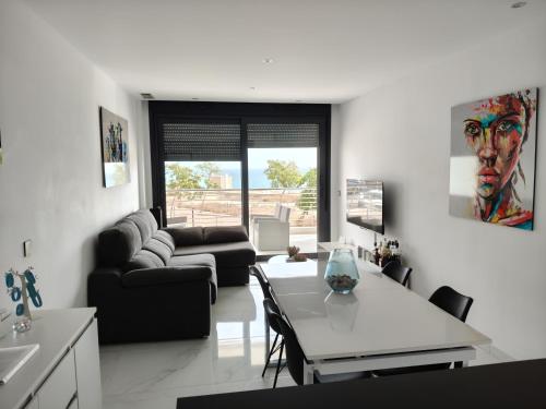 a living room with a couch and a table at infinityview sunrise in Arenales del Sol