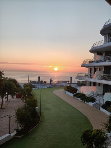 a view of the sunset from the balcony of a building at infinityview sunrise in Arenales del Sol