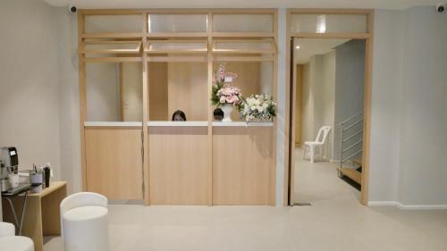 a room with a pivot door with flowers on it at The Staytion Hotel at Sukhumvit in Amphoe Phra Khanong