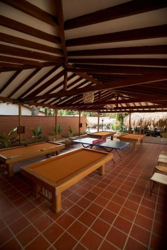 a group of ping pong tables on a patio at Hotel Quimbaya in San Jerónimo