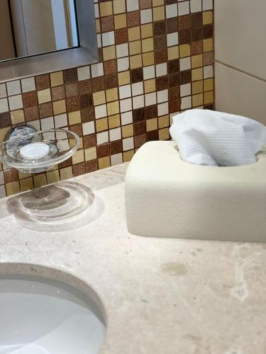 a bathroom with a counter with a sink and a mirror at أبحر ريزيدينس804 in Obhor