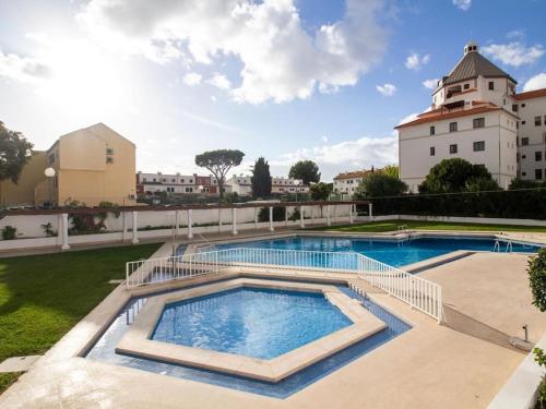 a large swimming pool with a building in the background at Vilamoura Marina Apartment by Stay ici in Vilamoura
