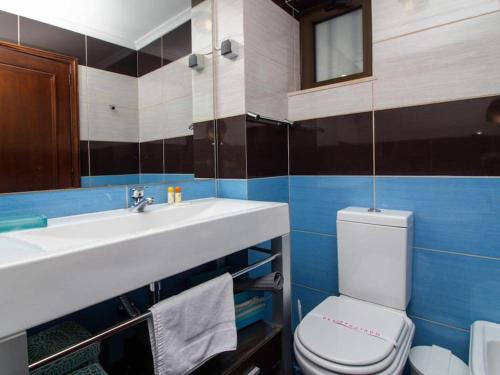 a bathroom with a sink and a toilet and a mirror at Vilamoura Marina Apartment by Stay ici in Vilamoura