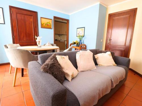 a living room with a couch and a table at Vilamoura Marina Apartment by Stay ici in Vilamoura