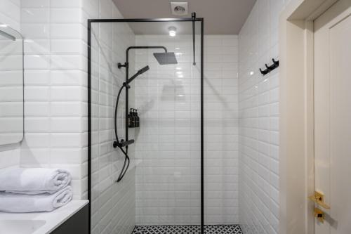 a bathroom with a shower with a glass door at Ridge Apartments in Chernivtsi
