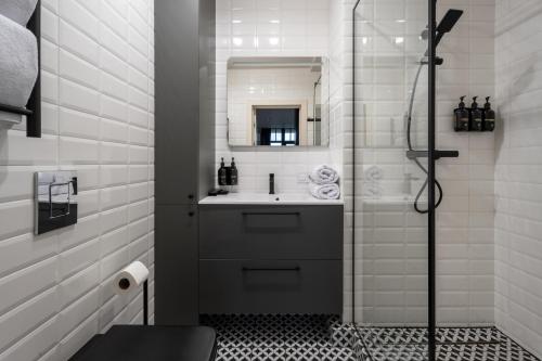 a bathroom with a sink and a shower at Ridge Apartments in Chernivtsi