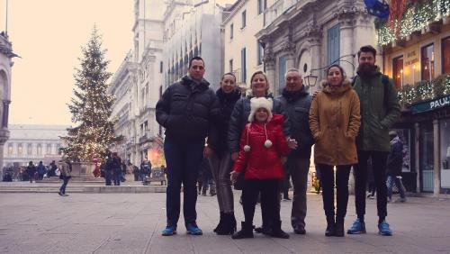 a group of people posing for a picture on a street at CASA ROMAN ITALIA, Center Sacile in Sacile