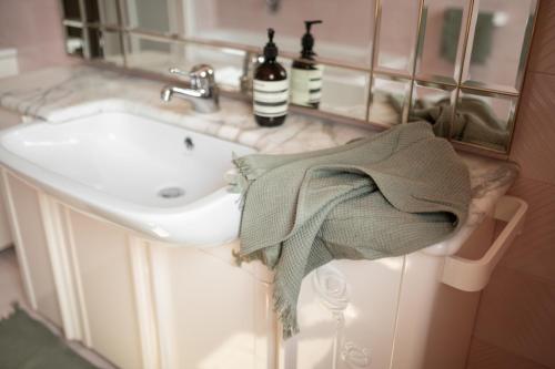 a bathroom with a sink and a towel at 240qm Luxus Apartment - Natur & Wandern zw Bozen und Meran in Nalles