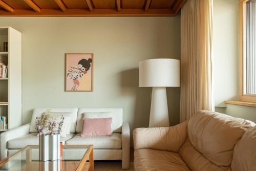 a living room with a couch and a table at 240qm Luxus Apartment - Natur & Wandern zw Bozen und Meran in Nalles