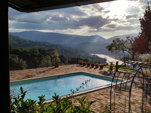 a swimming pool with a view of the mountains at Agriturismo Pascucci in Tolentino