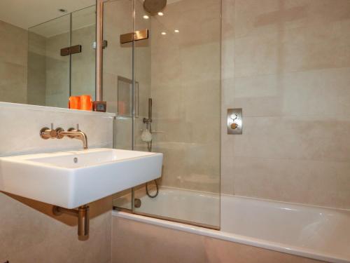 a bathroom with a sink and a shower at Fistral Tide in Newquay