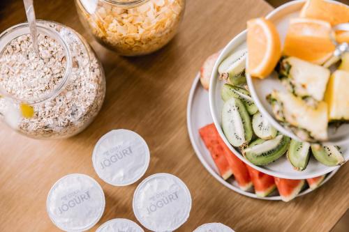 a table topped with a plate of fruit and a bowl of chiavari at Hlid Bed and Breakfast in Myvatn
