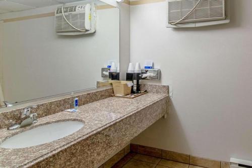 a bathroom with a sink and a mirror at Devils Lake Inn By OYO Near Devils Lake Regional Airport in Devils Lake