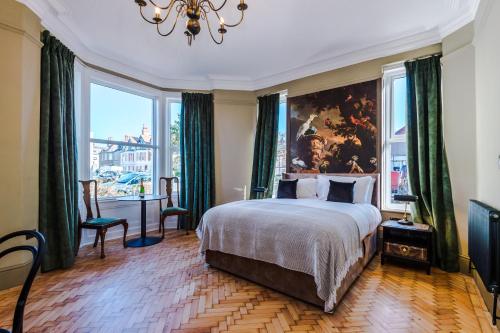 a bedroom with a bed and a large window at Tilstone Boutique Guest Accommodation in Llandudno