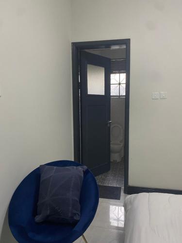 a room with a blue dog bed in front of a door at HA LUXURY TWO BEDROOMED Munyonyo in Gaba