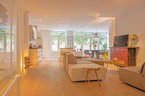 a living room with a couch and a table at TOP location 2 bedroom groundfloor home with garden in The Hague
