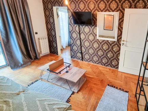 a living room with a table and a television at Red Clay Apartments City Club in Belgrade