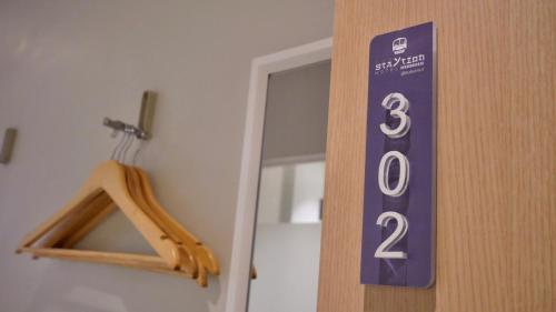 a sign on the door of a room at The Staytion Hotel at Sukhumvit in Amphoe Phra Khanong