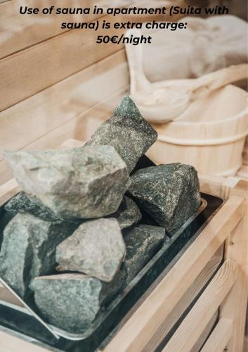 a pile of rocks in a wooden box with the words use of sound in equipment at NA Apartments in Maribor