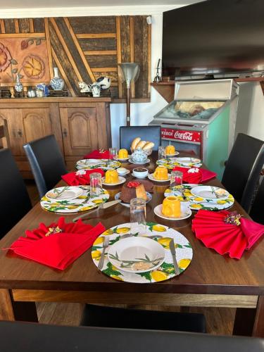 a table with plates of food on it in a kitchen at Flor de Limão Hotel Boutique in Coroa Vermelha
