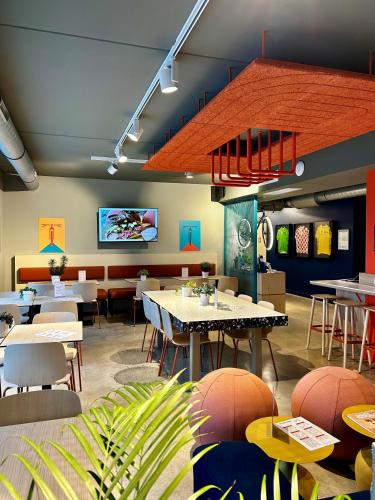 un restaurant avec des tables et des chaises et une télévision à écran plat dans l'établissement ibis budget Loudéac Vélodrome, à Loudéac