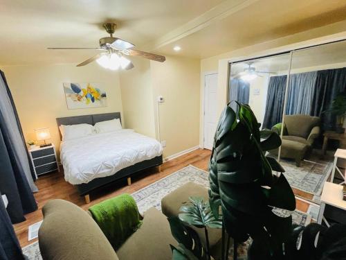 a bedroom with a bed and a living room at Exquisite Rogers Park 1 bedroom, 1 bath Apartment Near Evanston in Chicago