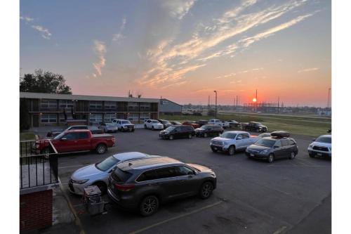 a parking lot with cars parked in front of a building at Devils Lake Inn By OYO Near Devils Lake Regional Airport in Devils Lake