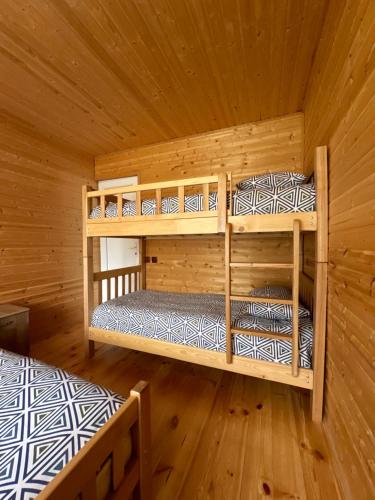 a room with two bunk beds in a cabin at Kvela Cottage - ყველა კოტეჯი in Gori
