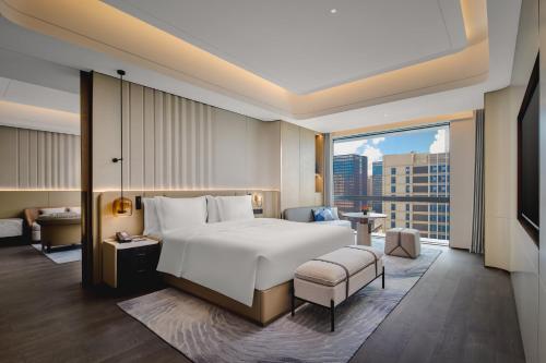 a hotel room with a bed and a large window at Crowne Plaza Kunshan East by IHG in Kunshan