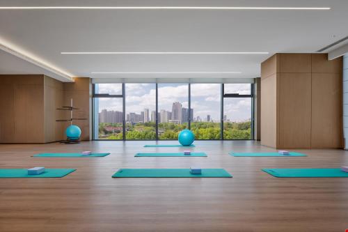 a yoga room with blue mats on the floor at Crowne Plaza Kunshan East by IHG in Kunshan