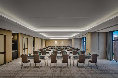 a conference room with a long table and chairs at Crowne Plaza Kunshan East by IHG in Kunshan