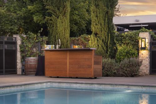 a wooden dresser next to a swimming pool at Napa Valley Marriott Hotel & Spa in Napa