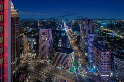 a city lit up at night with traffic at W Taipei in Taipei
